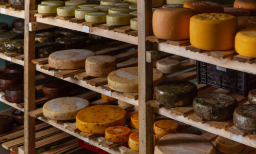 Cow,Milk,Cheese,,Stored,In,A,Wooden,Shelves,And,Left